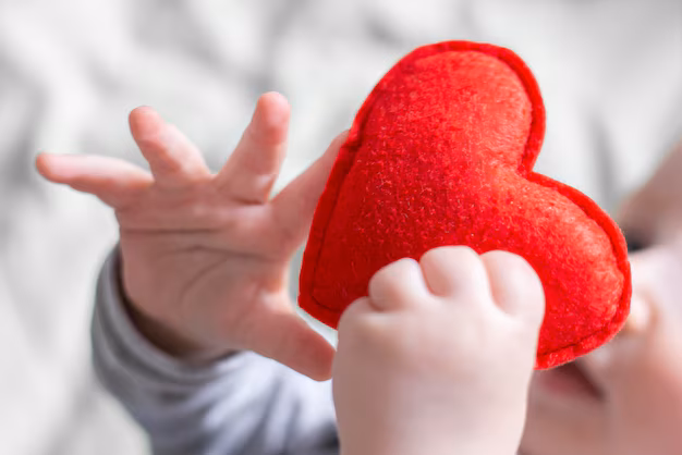 baby s hands hold red heart background bed linen children s health 101969 2129